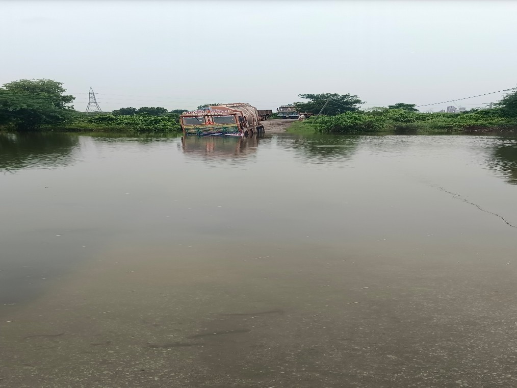 నీళ్లలో చిక్కుకుపోయిన లారీ