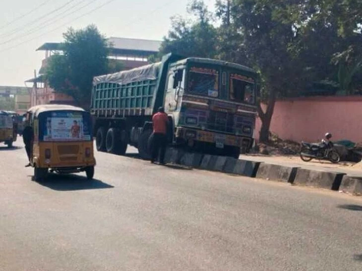 డివైడర్‌ను ఢీకొట్టిన లారీ